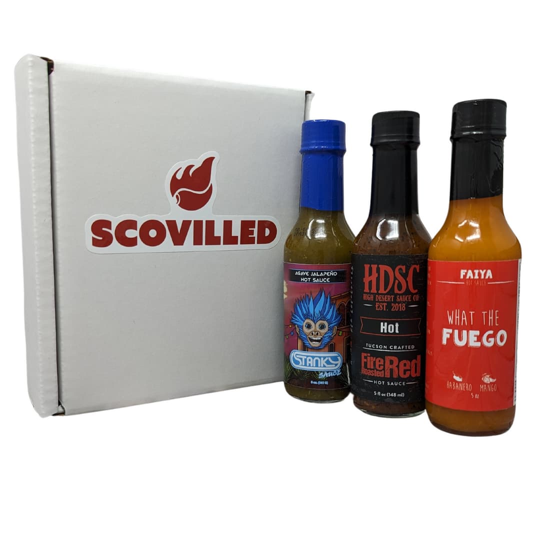 Scovilled subscription box with three artisan hot sauce bottles
